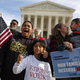 Rosario Reyes (behind flag) and her son Victor Reyes during a vigil and rally organized by the Fair Immigration Reform Movement and CASA in front of the Supreme Court in Washington, D.C., Dec. 11, 2015.
Chip Somodevilla/Getty Images